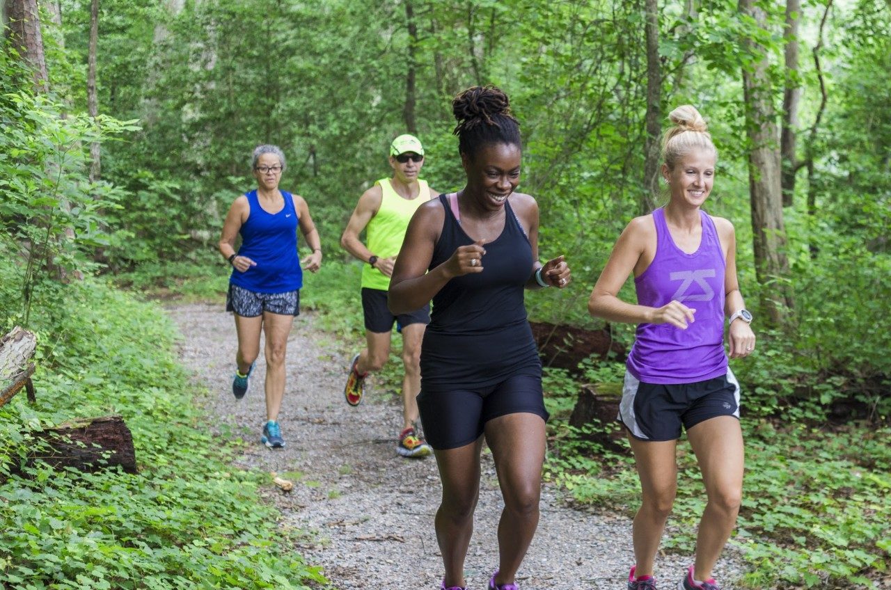 group of joggers on forest trail